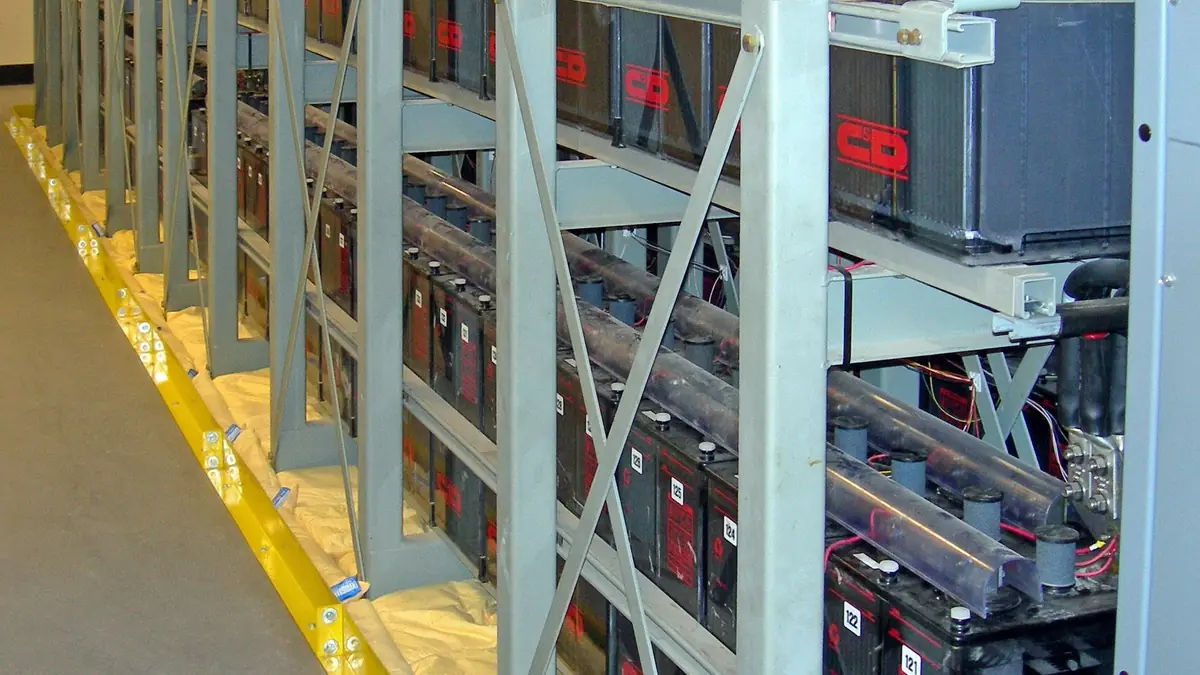 Racks of lead-acid UPS batteries in a large data centre, which carry the load until the diesel generators start