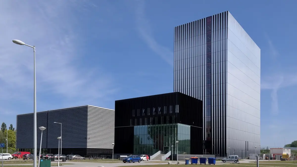 The Equinix AM3 and AM4 data centre buildings in Amsterdam, a low-rise hall beside a multi-storey data tower in the city