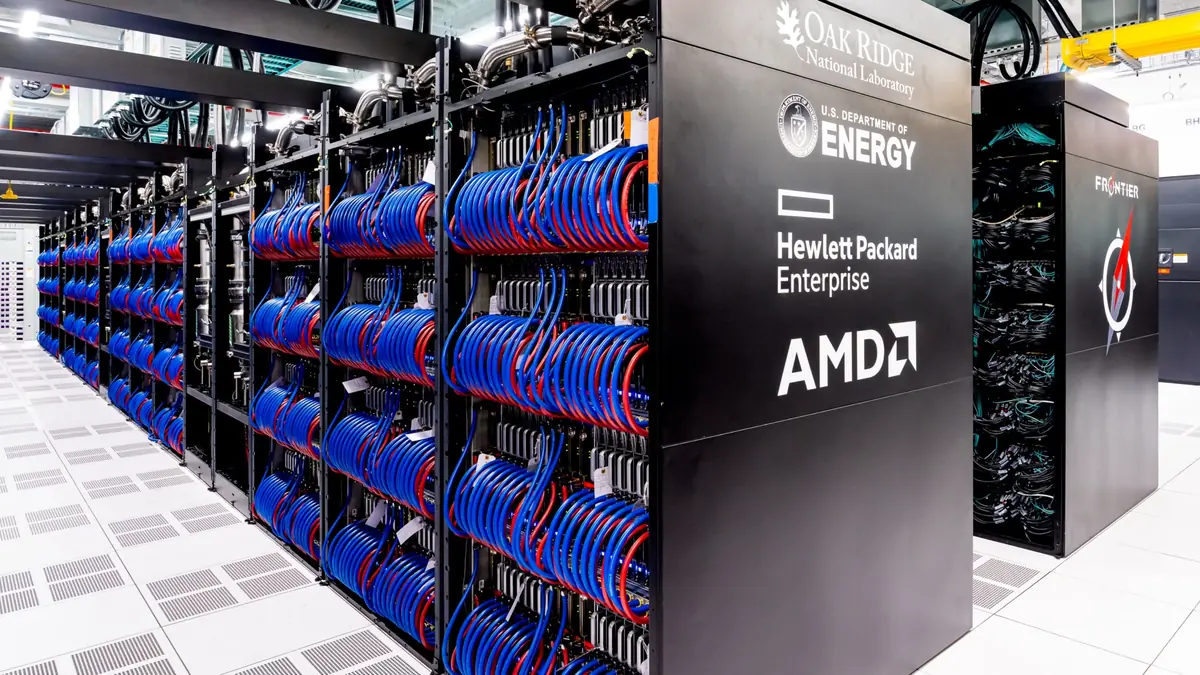 Open cabinets of the Frontier supercomputer, an HPE Cray EX system at Oak Ridge National Laboratory, packed with blue and red coolant hoses