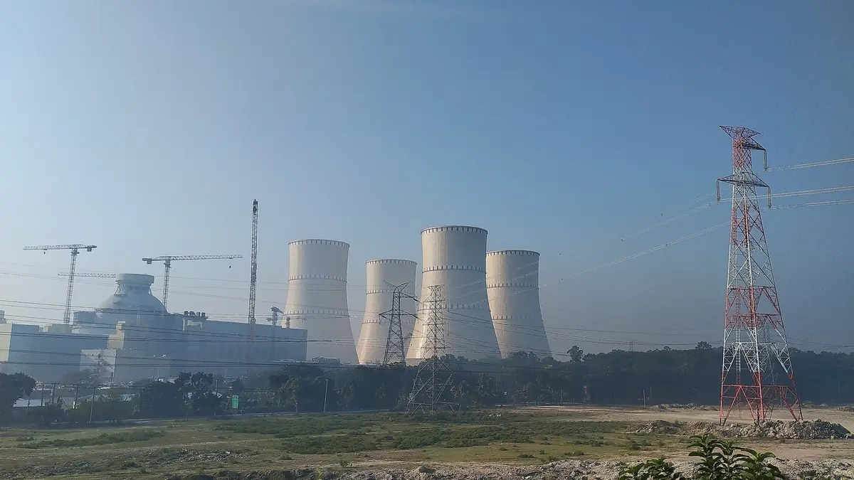 A nuclear power plant cooling tower, the generation data centres are contracting directly rather than queueing for grid capacity